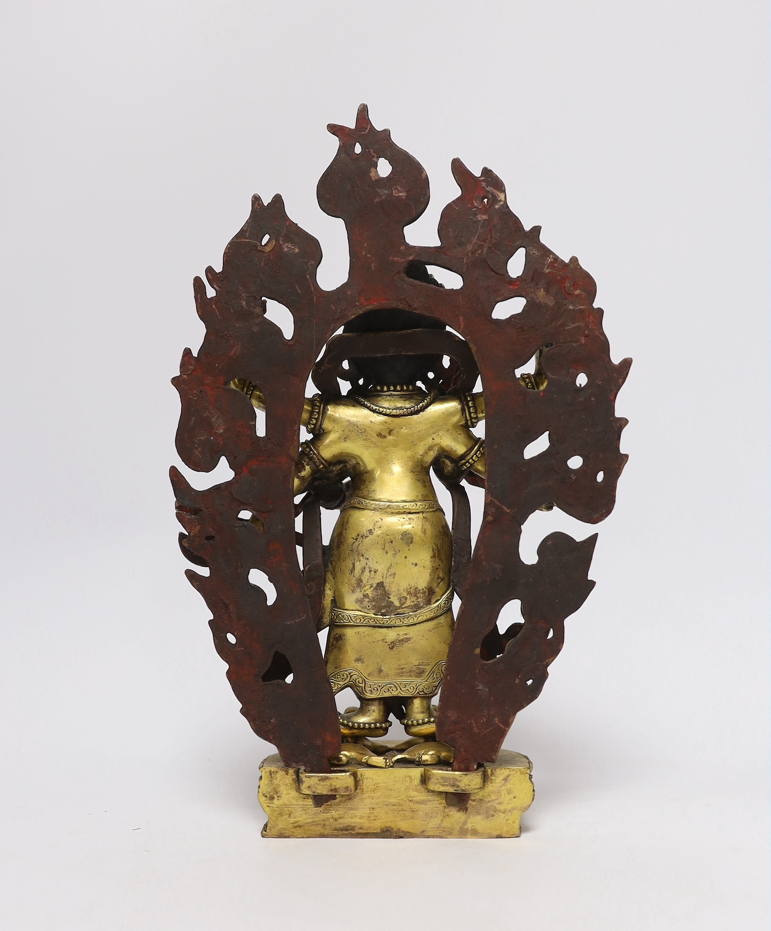 A Sino-Tibetan gilt bronze figure of Mahakala with flame form mandala, 29cm high